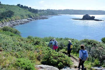 Fototapeta premium Senior hikers on the path along the sea in Brittany France