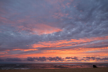 Fototapeta premium fisherman on the beach at sunset