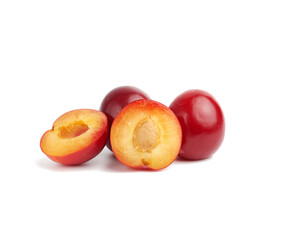 Fototapeta na wymiar ripe red whole and halves of plum isolated on white background