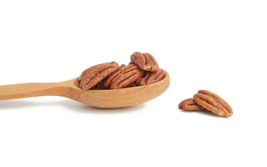 peeled pecans in a brown wooden spoon isolated on white background
