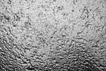 Close up view of a glass window covered with ice. Background.