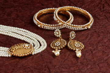 Pearl Jewelry on a textured background, Pearl bracelet, pearl necklace, pearl earrings, Style, fashion and design of jewelry. indian traditional jewellery,jewelry background