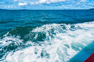 Water blue ocean splash and boat in the sea way ,Waves splashing on the side of ship