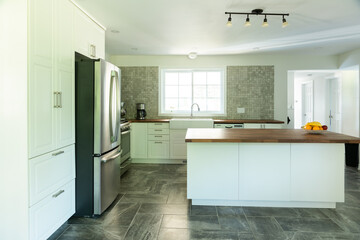 New bright kitchen with marble tiles