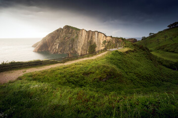Path to the sea. Horizontal picture of a landscape, with a zigzagging road to the coast. 
