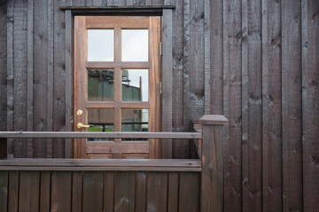 Door on wooden facade. Horizontal composition