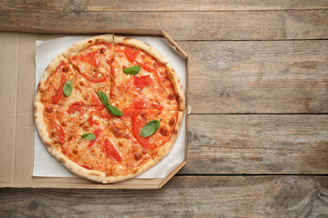 Delicious pizza Margherita on wooden table, top view. Space for text