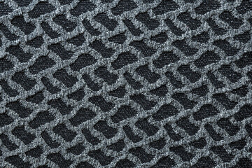Abstract texture of gray knitted fabric. Gray wool with random black accents.