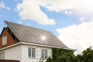 Building with installed solar panels on roof. Alternative energy source