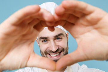 Smiling bearded male chef cook baker man in apron white t-shirt toque chefs hat isolated on blue...