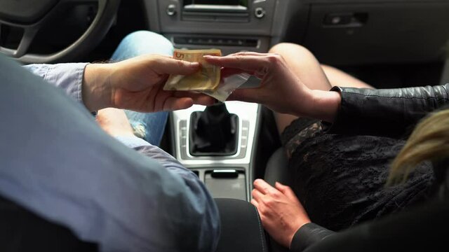 Drug dealer sells drugs to woman inside the car.