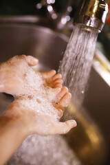 Fototapeta premium Hygiene rules. Hand washing before meals. Antibacterial treatment of hands with soap. A way to prevent virus infection. Coronavirus protection.