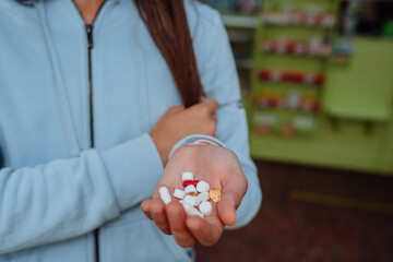 Coronavirus. Covid-19. A man or woman takes and shows pills.