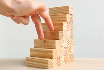Woman imitating stepping up on wooden stairs with her fingers at table, closeup. Career promotion concept © New Africa