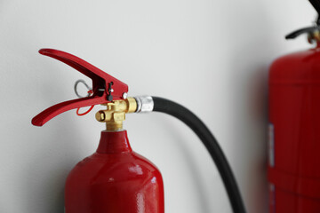 Fire extinguisher on white background, closeup view