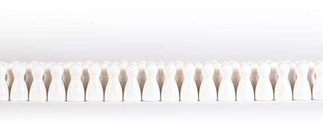 many white wooden figurines in a row