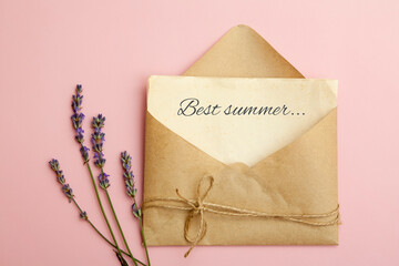 Top view of a leaf in an envelope with text Best summer and lavender on a pink background. The...