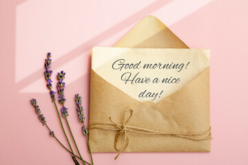 Top view of a sheet in an envelope with the text Good morning and lavender on a pink background.