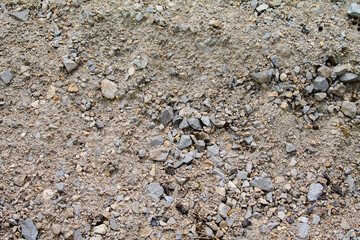 Texture gravel in its natural state with sand as background. As seen on the mountain.
