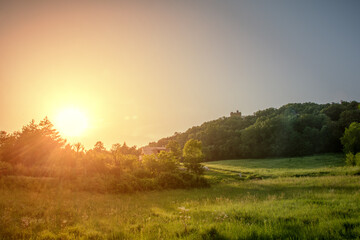 Fototapeta na wymiar Beautiful summer orange sunset landscape on country