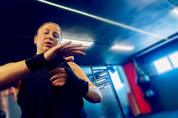 Young woman preparing for working out kickbox for healthy life and self defence.