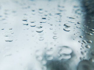 Closeup of rain drop on glass, Blurred background 