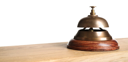 Hotel service bell on wooden table against white background, closeup