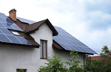House with installed solar panels on roof. Alternative energy source