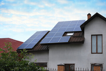 House with installed solar panels on roof. Alternative energy source