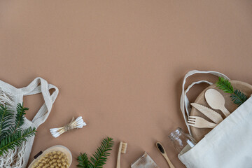 Cotton eco bag.  Zero waste concept.   Zero Waste Cotton Bag.  Eco friendly and reuse concept. Wooden toothbrushes, paper dishes, green leaves. Top view, flat lay,  copy space.