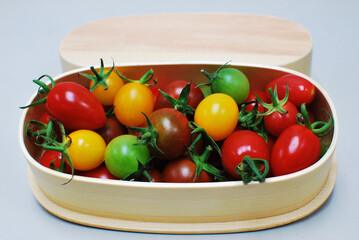 Colorful tomatoes in a wooden box
