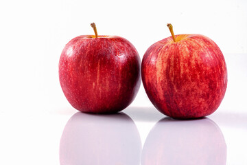 Two ripe red apples fruits with reflection isolated on white background. Red apples with clipping path.