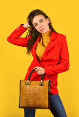 Fototapeta na wymiar Perfect design. Fashionable woman in jacket. Fashion autumn winter. female trendy beauty. handbag and accessories. Trendy girl holding small leather bag in hand. Stylish accessories. Beauty brunette