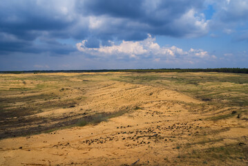 summer sandy desert under a dense cloudy sky