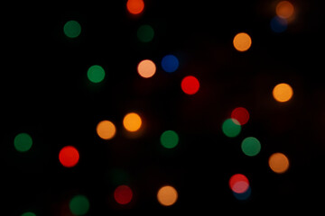 Abstract background with multi-colored bokeh lights.