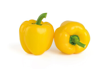 Two whole ripe yellow bell peppers isolated on a white background. Fresh ruits and vegetables, vegetarian food, raw food diet.