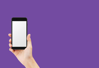 Hand holding black smartphone isolated on purple background