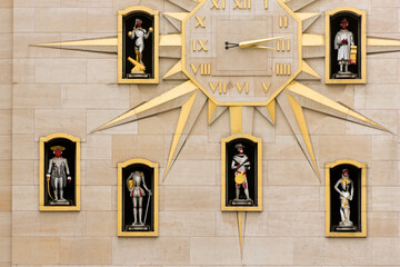The star-shaped clock and statues on the facade of the Mont des Arts carillon in Brussel