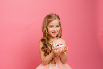 little girl with birthday cake on pink background