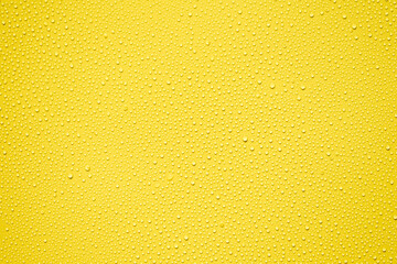 Water or rain drops on yellow plastic sheet background 
