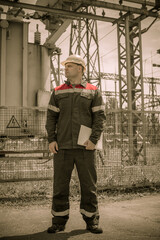 The energy engineer inspects the equipment of the substation. Power engineering. Industry.