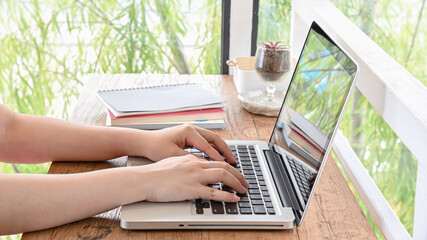 Woman working at home office hand on keyboard.