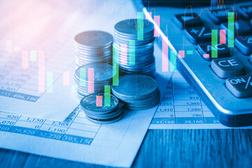 Stack of money coin on accounting sheet with trading graph, financial investment concept. 