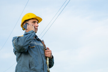 Industry. Energy. An energy engineer with a mobile phone in his hands. Electricity.