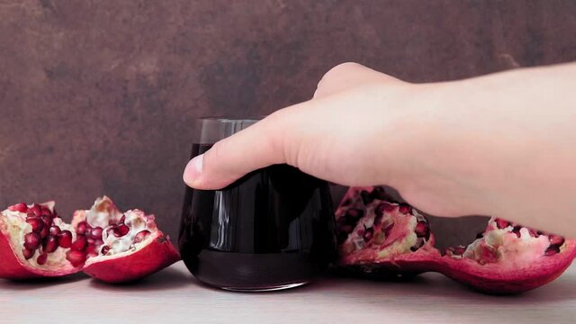 pomegranate juice. Open grenades and grains on the table. selective focus