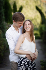 Fototapeta premium Beautiful young couple holding. Girl and guy in the park. Outside on nature. Happy couple
