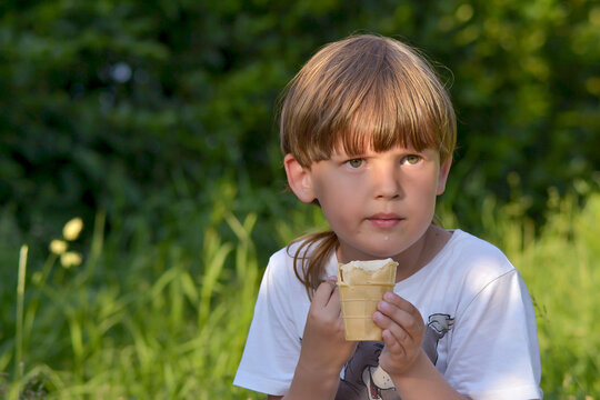 boy eating ice cream in the park