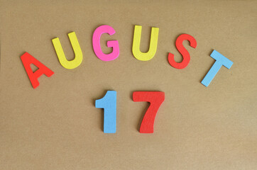 August 17, Toy alphabet with a brown background.