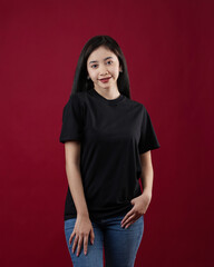Fototapeta premium Front view white t-shirt Closeup on female body, woman girl in empty black t-shirt isolated on red background. Design woman t-shirt template and mockup for print.