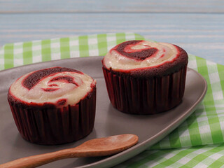 red velvet cupcake with wooden spoon  on the table
